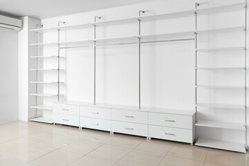 Empty shelves and drawers in modern wardrobe