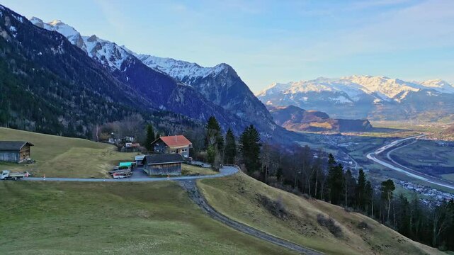 Aerial footage of beautiful valley in the Alps during spring at sunrise Liechtenstein and Switzerland
