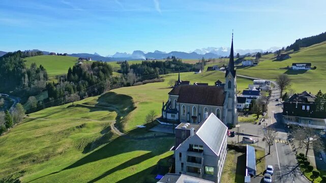 Aerial of little alpine village in the Alps of Switzerland in the early spring near Bennau