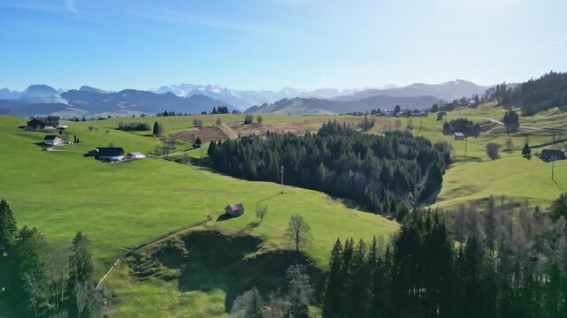 Aerial of little alpine village in the Alps of Switzerland in the early spring near Bennau