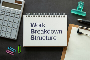 There is notebook with the word Work Breakdown Structure. It is as an eye-catching image.