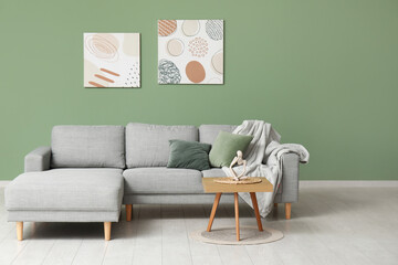 Interior of stylish living room with sofa, coffee table, plaid and pillows