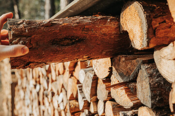 firewood.Preparing firewood for the heating season. Mens hands pull firewood from the woodpile.