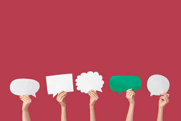 Female hands with different speech bubbles on red background