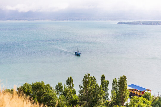 Western Asia, Eurasia, South Caucasus, Republic of Armenia. Sevan. View of tourist boat on Lake Sevan from the Sevanavank Monastery complex.