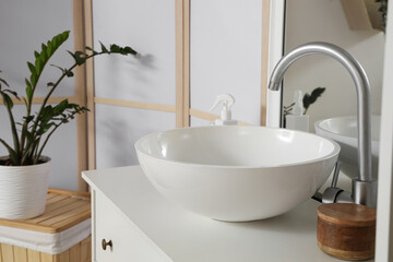 Ceramic sink on drawers in light bathroom, closeup