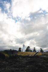 mountain landscape with clouds and a lighthouse