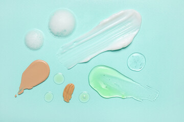 Composition with samples of cosmetic products on color background