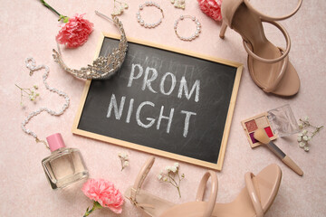Chalkboard with text PROM NIGHT, high heels, jewellery, makeup products and flowers on grunge pink...