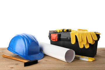 Hardhat, toolbox and construction tools on wooden table against white background
