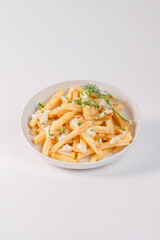 A bowl of french fries with a white plate. The fries are covered in a white sauce and are topped with parsley