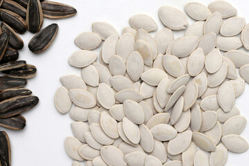 Roasted pumpkin seeds on white background.