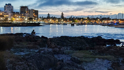 Rocky border and port at background, punta del este city, uruguay