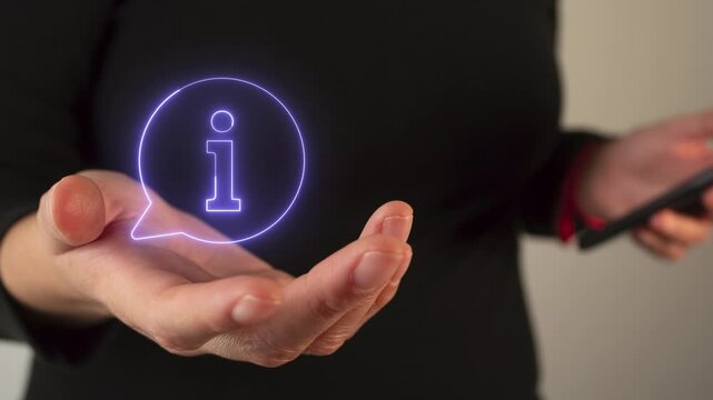 Woman's hand holding a virtual icon of a speech bubble with an i, information concept