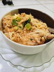 Creamy noodle soup with chicken and spices.
