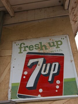 Old-fashioned 7up sign on old building. "fresh up with 7up"
