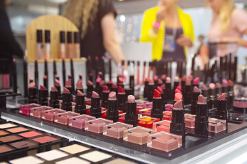 Shelves are lined with an array of colorful lipsticks, showcasing various shades