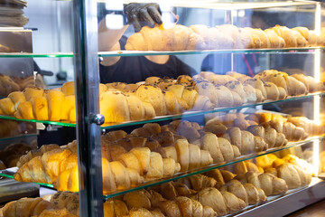Fresh delicious croissants on display in the bakery