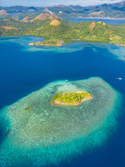Turquoise clear water with coral reefs around in CYC Beach. Coron, Palawan. Philippines.