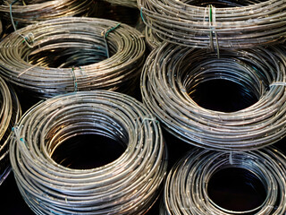 Coiled Metal Wires: A detailed, industrial image of neatly coiled metal wires, presenting a sense of order, precision, and the inherent strength of the material.