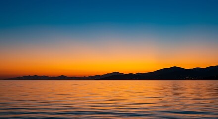 Obraz premium Ocean Sunset with Mountain Silhouette