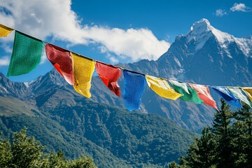 Colorful prayer flags are hanging with mountains in the background