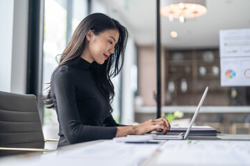 Beautiful confident asian business woman working with laptop Hands typing  keyboard. Professional...