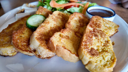 Delicious French toast served with salad and sauce at brunch