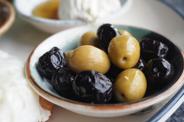 Assorted olives served in a bowl on a dining table