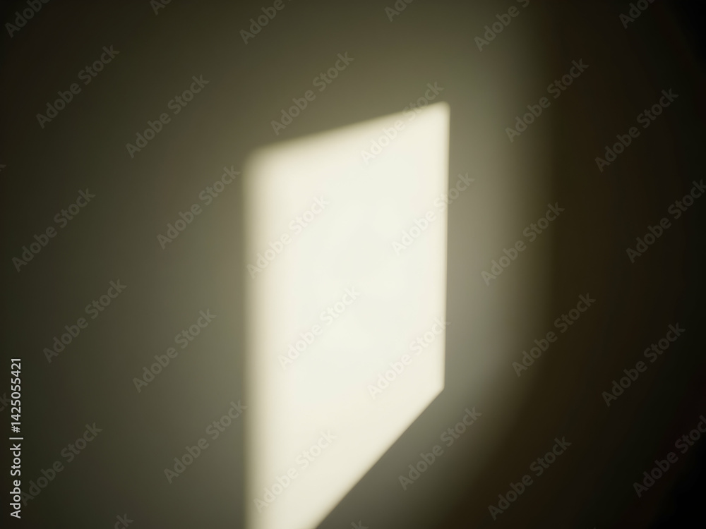 Poster abstract luminous window shadow with a soft glow and blurred edges casting a geometric shape on a wa
