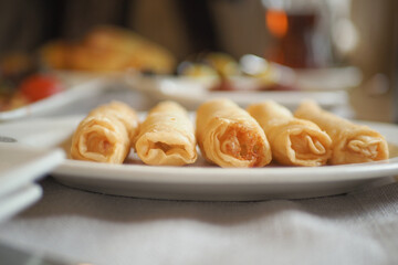 Delicious rolled pastries served on a white plate at a restaurant