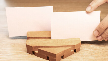 White blank business card mockup with wooden decoration on wooden background