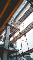 Obraz premium Industrial Interior Architecture Featuring Metal Pipes and Scaffolding under Construction Bright Sky