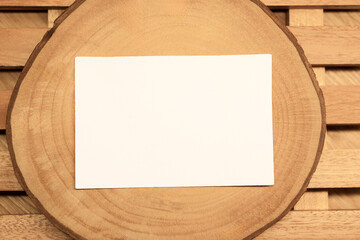 White blank business card mockup with wooden decoration on wooden background