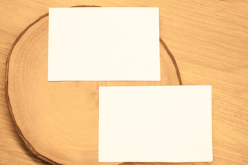 White blank business card mockup with wooden decoration on wooden background