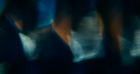 Optical texture. Blur light sparkle. Defocused golden yellow colorful lens flare on abstract art bokeh modern dark black background.