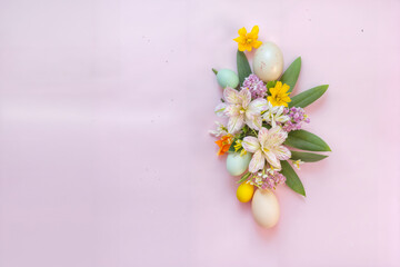 The image features a decorative arrangement of Easter eggs and flowers on a pastel pink background