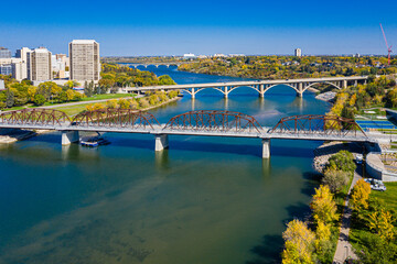 Bridge spans a river with a city in the background