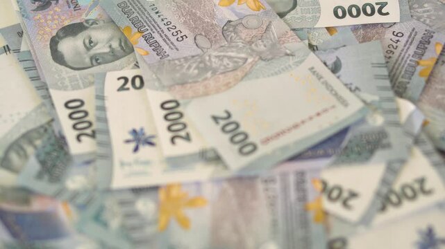 Closeup. View when stacking two thousand rupiah bills. suitable for finance, banking, investment, business and savings.