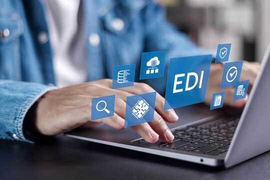 EDI Electronic Data Interchange concept. Platform for exchanging business documents between organizations. Businessman using laptop with EDI icons on virtual screen.