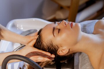 Japanese head spa treatment: Relaxing scalp massage at a beauty salon, young woman enjoying a calming hair wash and rejuvenating experience