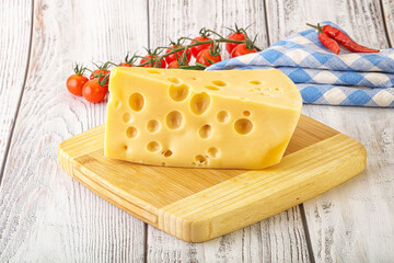 Maasdam cheese piece over board