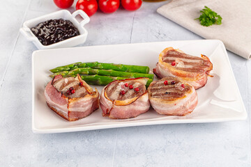 Tasty grilled pork medallion with bacon