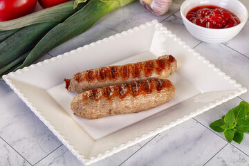 Grilled pork sausages served tomato sauce
