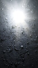 Abstract image of a reflective surface with scattered stones and bright light.