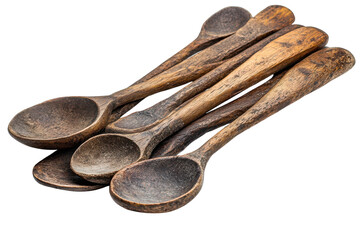 A stack of rustic aged wooden spoons showing signs of use and time on a stark black background on transparent background