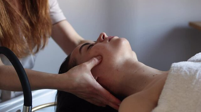 Japanese head spa treatment: Relaxing scalp massage at a beauty salon, young woman enjoying a calming hair wash and rejuvenating experience