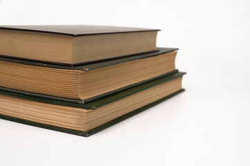 a stack of three books on a white background. concept