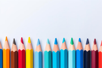 Colorful pencils arranged in neat row on white background