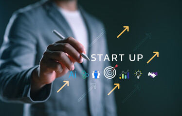 Businessman writing "Start Up" with digital icons of AI, target, data, light bulb, and growth arrows, representing innovation, entrepreneurship, technology, and business startup success.